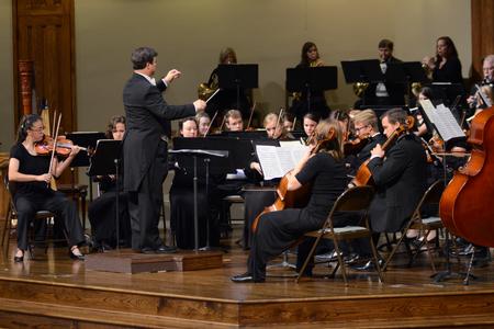 Michael Mann, assistant professor of music, conducts the orchestra in their concert at First Baptist Church in Jackson, Tenn. - Photo by MiKalla Cotton