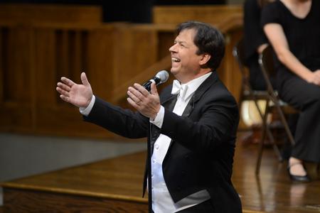Michael Mann, assistant professor of music, introduces the orchestra during their concert at First Baptist Church in Jackson, Tenn. - Photo by MiKalla Cotton