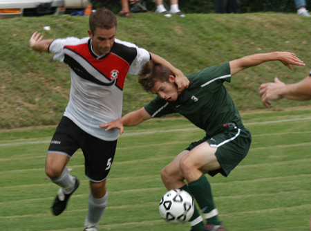 Dan Lee (5) battles a Belhaven player for possesion. - Photo by Jonathan Blair