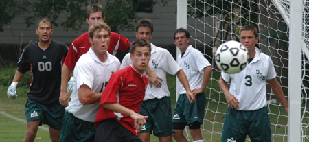 Bobby McColl (front red), along with other Union and Delta State players, await the ball duirng a corner kick. - Photo by Jonathan Blair
