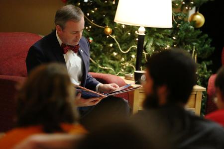 Dub Oliver, president of the university, reads The Night Before Christmas to the students gathered in the McAfee Commons for Christmas with the Olivers.  - Photo by Kristi McMurry Woody