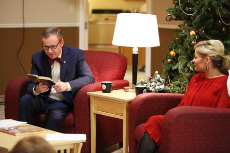 Dub Oliver, president of the university, reads a passage from Luke 2 to the students gathered in McAfee Commons for Christmas with the Olivers. - Photo by Kristi McMurry Woody