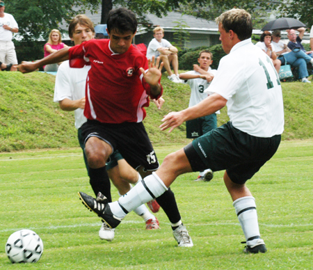 Diego Rojas (15)attempts to dribble through two Delta State defenders. - Photo by Jonathan Blair