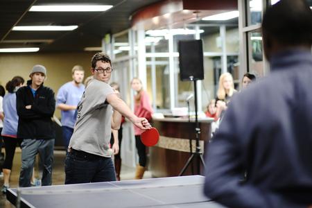 Students gather to watch a Brandon Sickling, junior music education major, and other students playing in a ping pong tournament in the Bowld Student Commons over J-term. - Photo by Kristi McMurry Woody