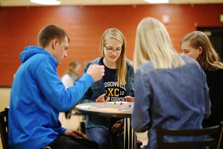 Abigail Berends (center), freshman special education major, plays Bunco with fellow students during a res-life sponsored tournament. - Photo by Kristi McMurry Woody