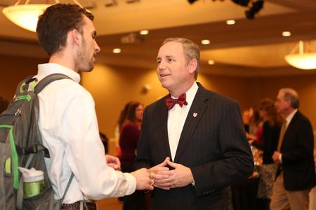 Dub Oliver, president of the university, talks with Joshua Guthrie, senior engineering major, at a reception held for students on the President's List for fall 2014.  - Photo by Kristi McMurry Woody