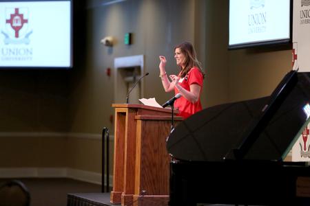 Katie Green, sophomore nursing major, gives her testimony at the beginning of the West Tennessee Pastors and Wives Valentine's Banquet held in the Carl Grant Events Center.  - Photo by Kristi McMurry Woody