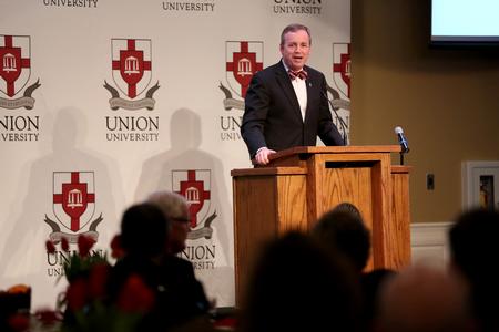 Dub Oliver, president of the university, welcomes guests and introduces the speaker for the West Tennessee Pastors and Wives Valentine's Banquet. - Photo by Kristi McMurry Woody