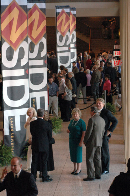 The Jackson community mingles in the lobby of the Carl Perkins Civic Center as they await the start of the Eighth Annual Scholarship Banquet.  - Photo by Lindsay Stavish