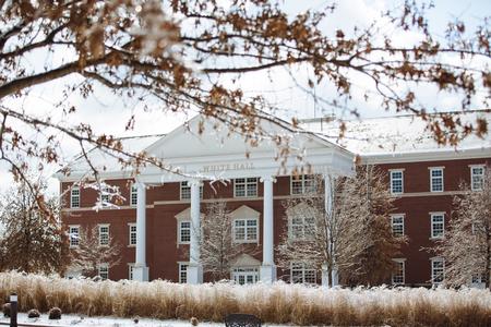 The campus was covered in a thin layer of snow one week after lots of ice and snow fell across the area. Pictured is White Hall. - Photo by Kristi McMurry Woody