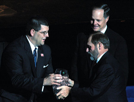 James Ayers, co-chairman of the recently completed <i>Building a Future</i> campaign, receives an engraved crystal vase presented by Charles Fowler and Mike Weeks during the Scholarship Banquet.  - Photo by Lindsay Stavish