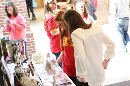 Members of Chi Omega look through the scrapbook set up at the Student Organization Fair in the SUB hallway. - Photo by Kristi McMurry Woody