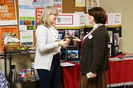 Susan Bolyard, program coordinator for the IIIS, Victoria Malone, coordinator of study abroad, talk during the External Study Fair where students can learn about opportunities to study abroad. - Photo by Kristi McMurry Woody