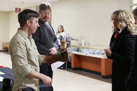James Kerfoot, assistant professor of biology, shows off one of the department's birds during the External Study Fair. The event gives students an opportunity to learn about study abroad opportunities, including one with the biology department. - Photo by Kristi McMurry Woody