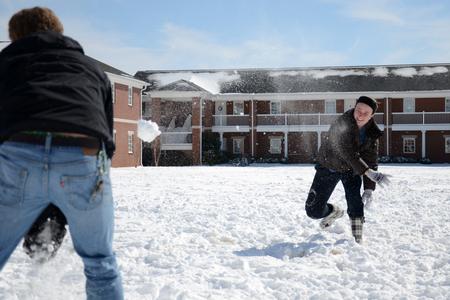 Sarah Troxel, sophomore intercultural studies major, throws snowballs at Anderson Underwood, sophomore intercultural studies major, during a snow day. - Photo by MiKalla Cotton