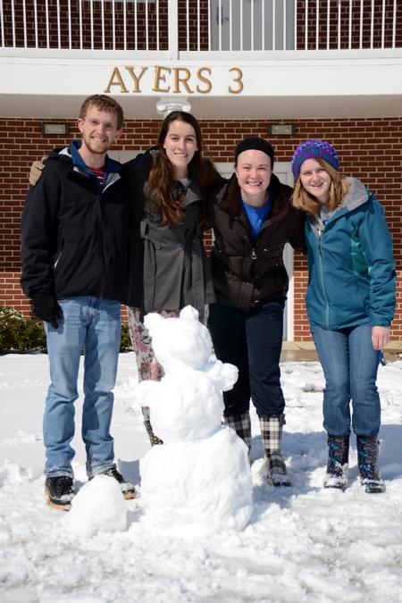 Anderson Underwood, sophomore intercultural studies major, Kristine Burgess, sophomore nursing major, Sarah Troxel, sophomore intercultural studies major, and Hannah Porter, sophomore biology major, pose with their snow bear on a snow day. - Photo by MiKalla Cotton