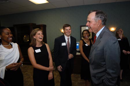 Former President George H.W. Bush laughs with Lauren Oldham, a senior from Martin, Tenn., and other Union students. - Photo by Morris Abernathy