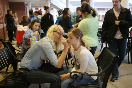 Julie Martin, junior TESL major, paints faces during an event hosted by Residence Life during Sibling Weekend. - Photo by Kristi McMurry Woody