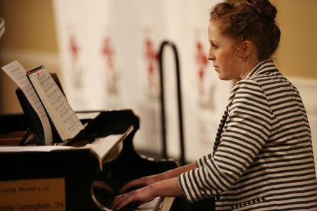 Melody Curtis plays the piano during a hymn sung at the Ryan Center Bible Conference. - Photo by Kristi McMurry Woody