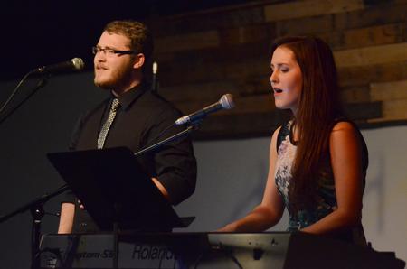 Jordan Mathenia, sophomore music major, and Autumn Hitt, senior philosophy major, perform during Open Mic Night in Barefoots Joe. - Photo by MiKalla Cotton