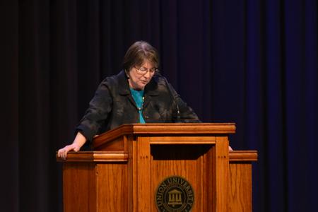 Mary Anne Poe, professor and associate dean of social work, prays for the Go trip to Louisville. - Photo by Meg Rushing