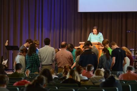 Julie Bradfield, director of student mobilization, prays over students concluding the GO Trip report chapel. - Photo by MiKalla Cotton