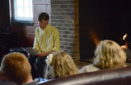 Hunter Martin, senior accounting major, reads a few pieces during the English portion of the Scholarship Symposium in the fireplace room of the Bowld Student Commons. - Photo by MiKalla Cotton