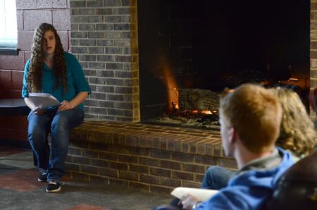 Amanda Vernon, freshman English major, reads during the English portion of the Scholarship Symposium in the fireplace room of the Bowld Student Commons. - Photo by MiKalla Cotton
