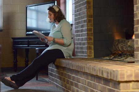 Kristen Wilson, senior psychology major, reads during the English portion of the Scholarship Symposium in the fireplace room of the Bowld Student Commons. - Photo by MiKalla Cotton