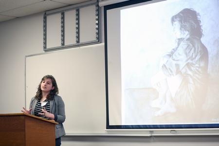 Katie Williams, senior art major, presents her body of drawing work at the Twelfth Annual Scholarship Symposium. - Photo by Amanda Rohde