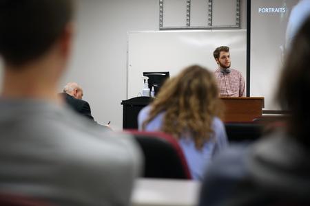 Thomas Griffith, junior art major, speaks on his painting and drawing portfolio at the Twelfth Annual Scholarship Symposium. - Photo by Amanda Rohde