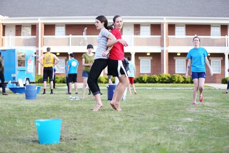 Students transport a water balloon between their backs to a bucket during Field Day outside the Bowld Student Commons. - Photo by Kristi McMurry Woody