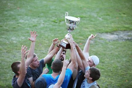 The men of Grey hoist up their newly earned Union Cup in celebration of winning. - Photo by Kristi McMurry Woody