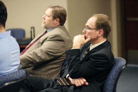 Kevin Westbrook, professor of marketing, listens to his students present their marketing plan to a local non-profit.  - Photo by Kristi McMurry Woody