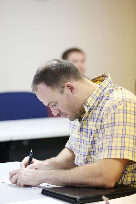 An MBA student takes notes during his class on the Germantown campus. - Photo by Kristi McMurry Woody