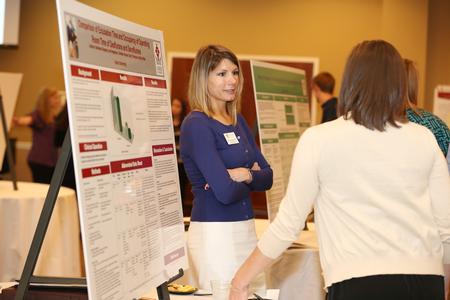 Ana Dragoiescu, doctor of nursing practice student, presents her research at the Scholarship Symposium poster sessions. - Photo by Kristi McMurry Woody