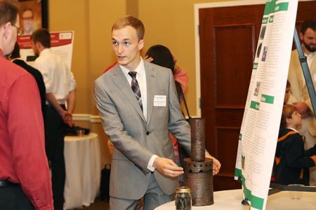 Matt Bentley, senior engineering major, presents his final project at the Scholarship Symposium poster sessions. - Photo by Kristi McMurry Woody