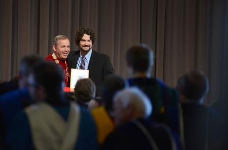 Scott Heit, assistant vice president for university communications, receives the 2015-2016 Gary L. Carter Staff of the Year award from Dub Oliver, president of the university, during Awards Day Chapel. - Photo by MiKalla Cotton