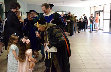 Faculty and staff congratulate the family of Scott Heit, assistant vice president for university communications, for receiving the 2015-2016 Gary L. Carter Staff of the Year award, following Awards Day Chapel. - Photo by MiKalla Cotton