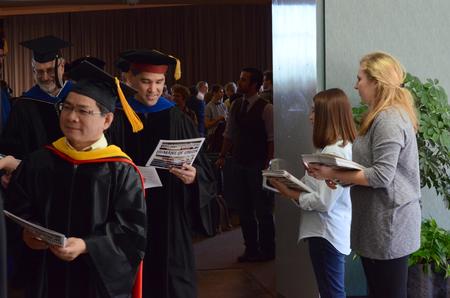 Cardinal & Cream staff hand out magazines to faculty and staff as they file out of Awards Day Chapel. - Photo by MiKalla Cotton