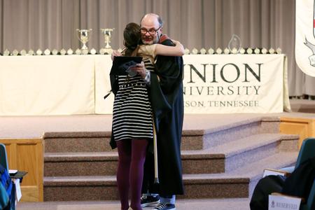 Megan Kersey, senior studio art major, receives an academic excellence medal from Lee Benson, professor of art and department chair. - Photo by Kristi McMurry Woody