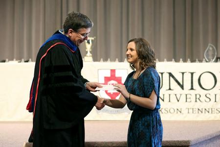 During Awards Day, Randy Johnston, university professor of chemistry and department chair, awards Kathryn Baugher, freshman chemistry major, the Bettye and Kermit Whiteaker Chemistry Award, which is presented to a freshman chemistry major or minor with outstanding scholastic achievement.  - Photo by Kristi McMurry Woody