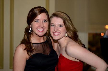 Emily Shaw, junior nursing major, and Erin Hennesy, junior nursing major, smile for a photo while enjoying the Cardinal Ball. - Photo by Meg Rushing