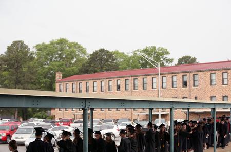 Graduates line up and wait for the processional at the spring graduation service. Traditional undergraduate students had a later graduation time this year to help with crowds from a record-breaking graduating class.  - Photo by Amanda Rohde