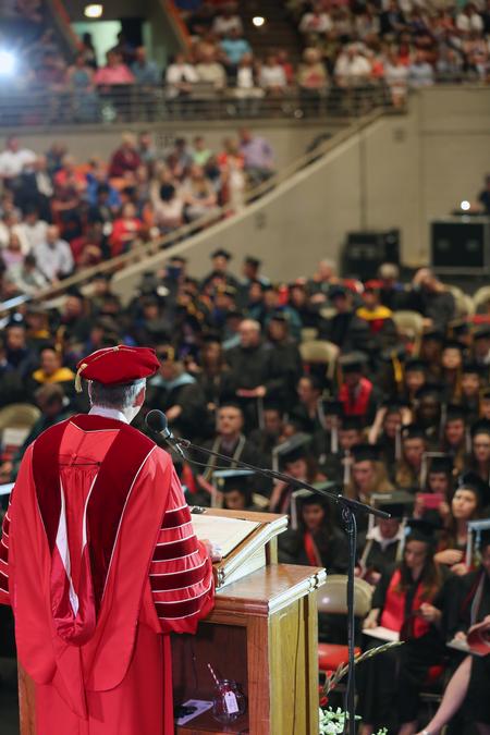 Dub Oliver, president of the university, addresses the crowd at the spring graduation. - Photo by Amanda Rohde