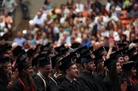 Graduates listen during the senior class presentation at the spring graduation. - Photo by Amanda Rohde