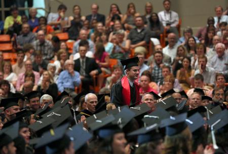 Phillip Kurzweil, biochemistry graduate, walks to the stage to accept the Tigrett Medal. - Photo by Amanda Rohde