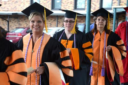 Doctor of Nursing Practice graduates smile as they walk into the Oman Arena for Union University's 190th Spring Commencement Services.  - Photo by Emily Stookey