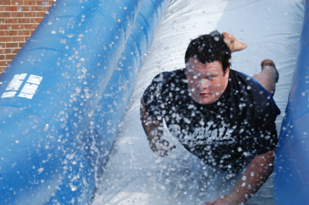 Freshman Jeff McCormick plunges head first into the water on the aqua slide during Fall Fest '04. - Photo by Jonathan Blair