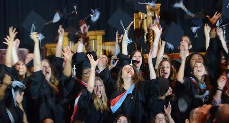 Master of Education graduates celebrate by throwing caps after the ceremony. - Photo by Elizabeth Wilson